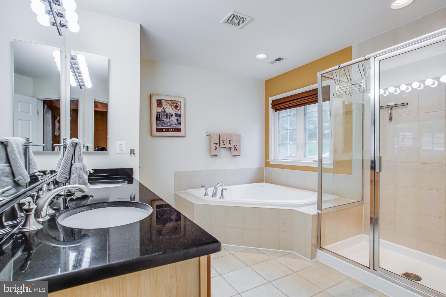 3403 Logstone Drive Triangle, VA 22172 - Photo 35 of 66 a bathroom with a sink double vanity granite tub shower and a mirror