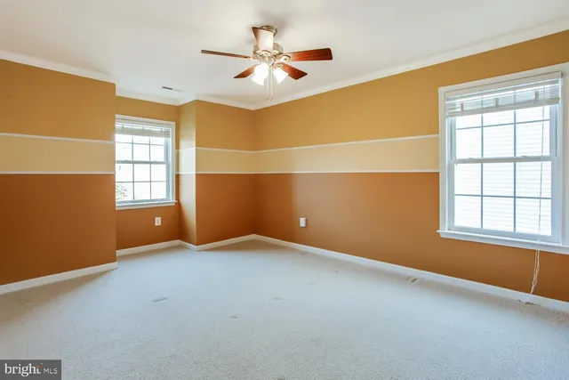 a living room with furniture and a kitchen view