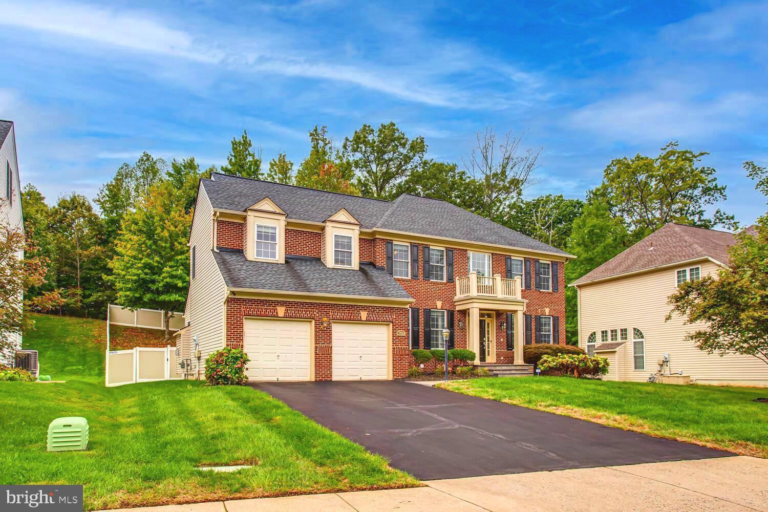 3403 Logstone Drive Triangle, VA 22172 - Photo 4 of 66 a front view of a house with a yard and trees