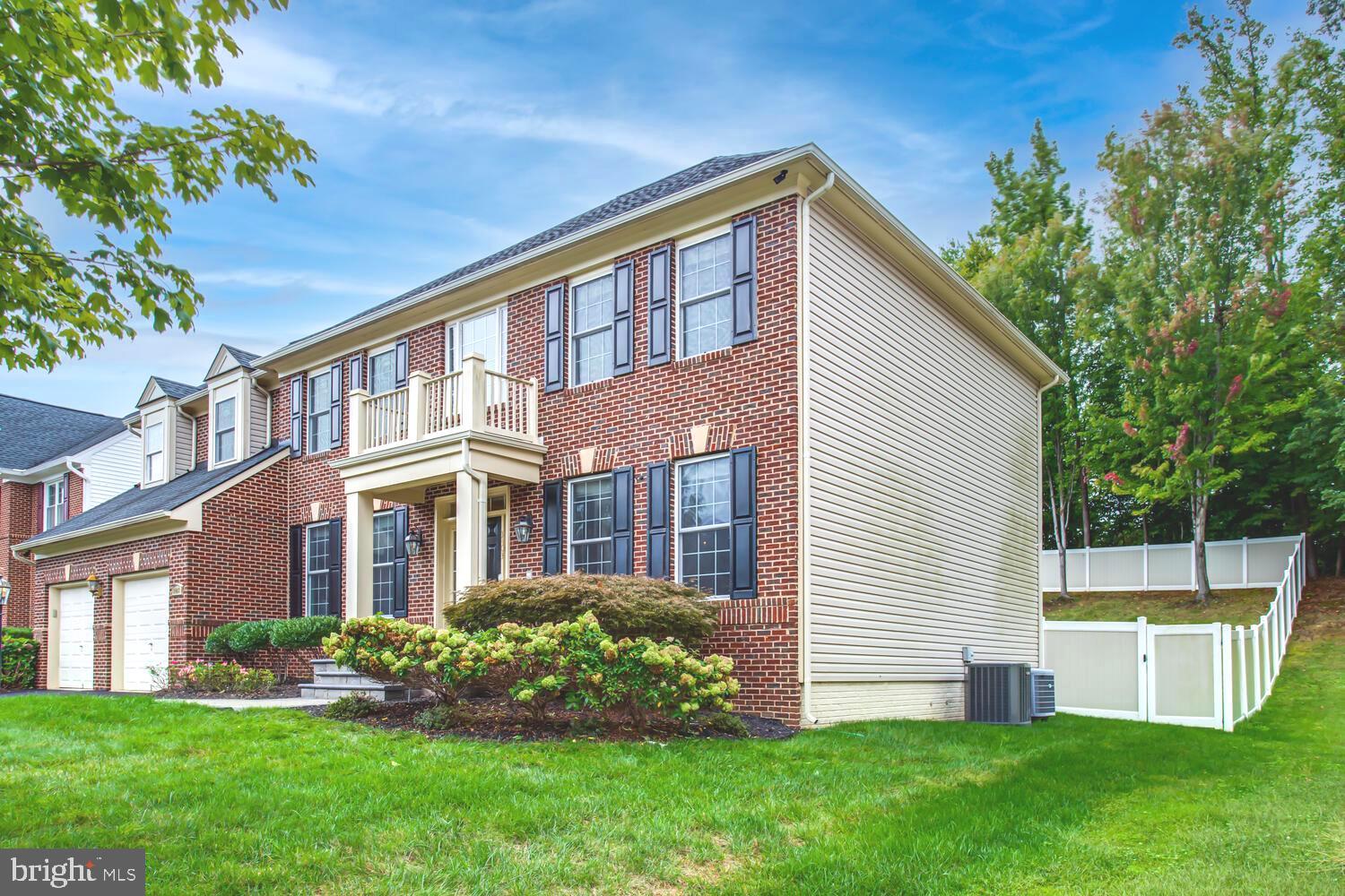 3403 Logstone Drive Triangle, VA 22172 - Photo 59 of 66 a front view of a house with a yard and trees