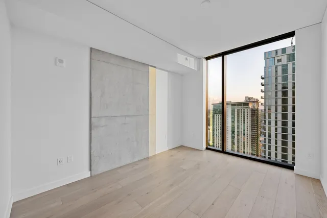 a view of a room with wooden floor and sliding door