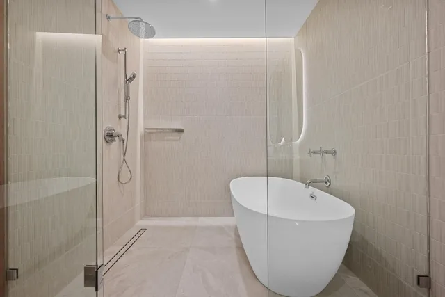a bathroom with a bathtub and shower