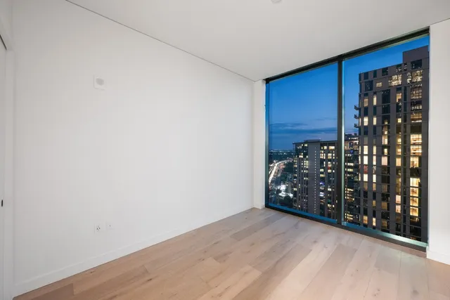 a view of a room with wooden floor