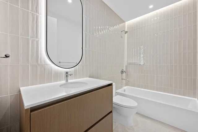 a bathroom with a sink a toilet and a mirror