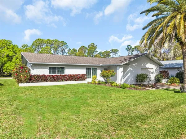a front view of house with yard and outdoor seating