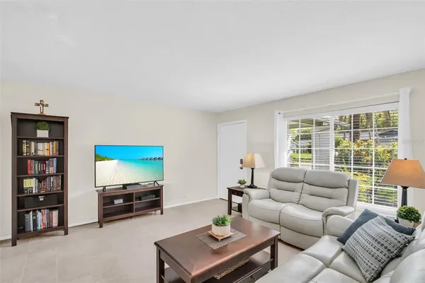 a view of a bedroom with a bed and a window