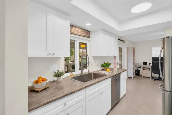 a kitchen with stainless steel appliances granite countertop a refrigerator and a stove top oven