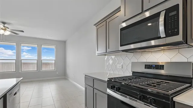 a kitchen with stainless steel appliances a sink stove and refrigerator