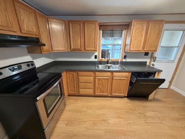 824 12th Street North Virginia, MN 55792 - Photo 3 of 34 Kitchen featuring stainless steel electric range, dark countertops, light wood-style flooring, and dishwasher