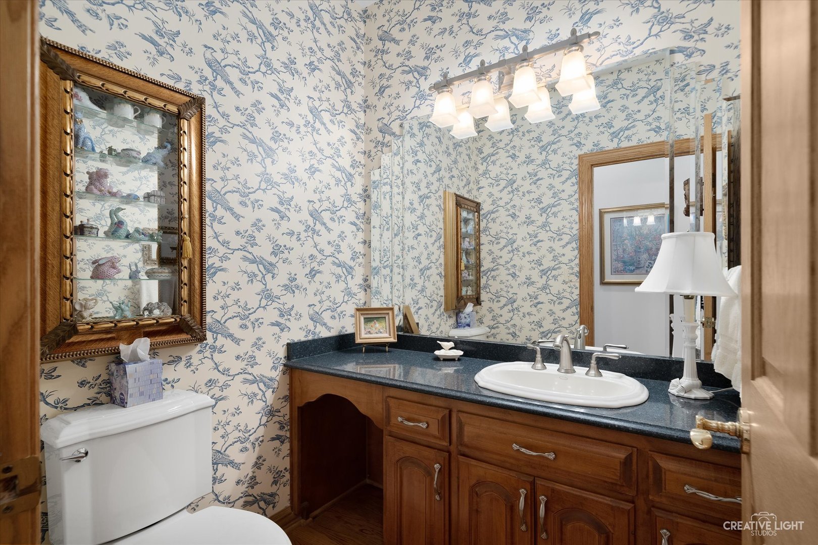 3293 Oak Knoll Road Carpentersville, IL 60110 - Photo 16 of 44 a bathroom with a granite countertop sink a toilet and mirror