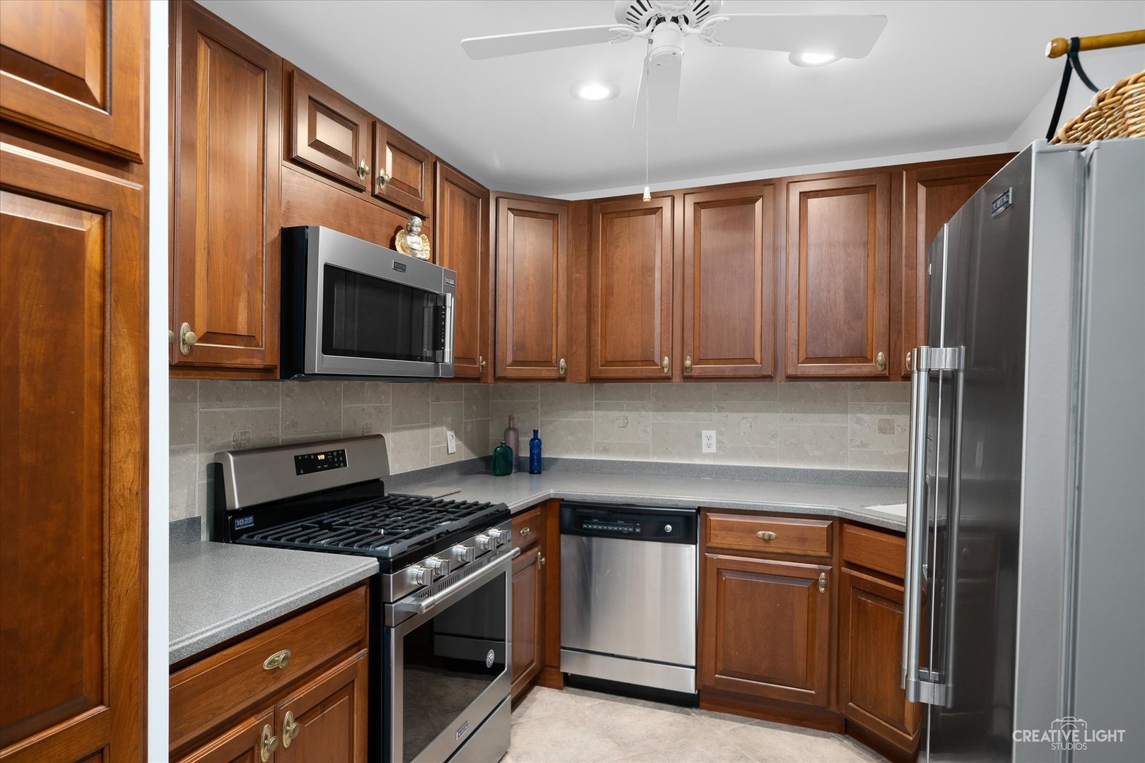 3293 Oak Knoll Road Carpentersville, IL 60110 - Photo 33 of 44 a kitchen with stainless steel appliances granite countertop a stove top oven a sink and dishwasher