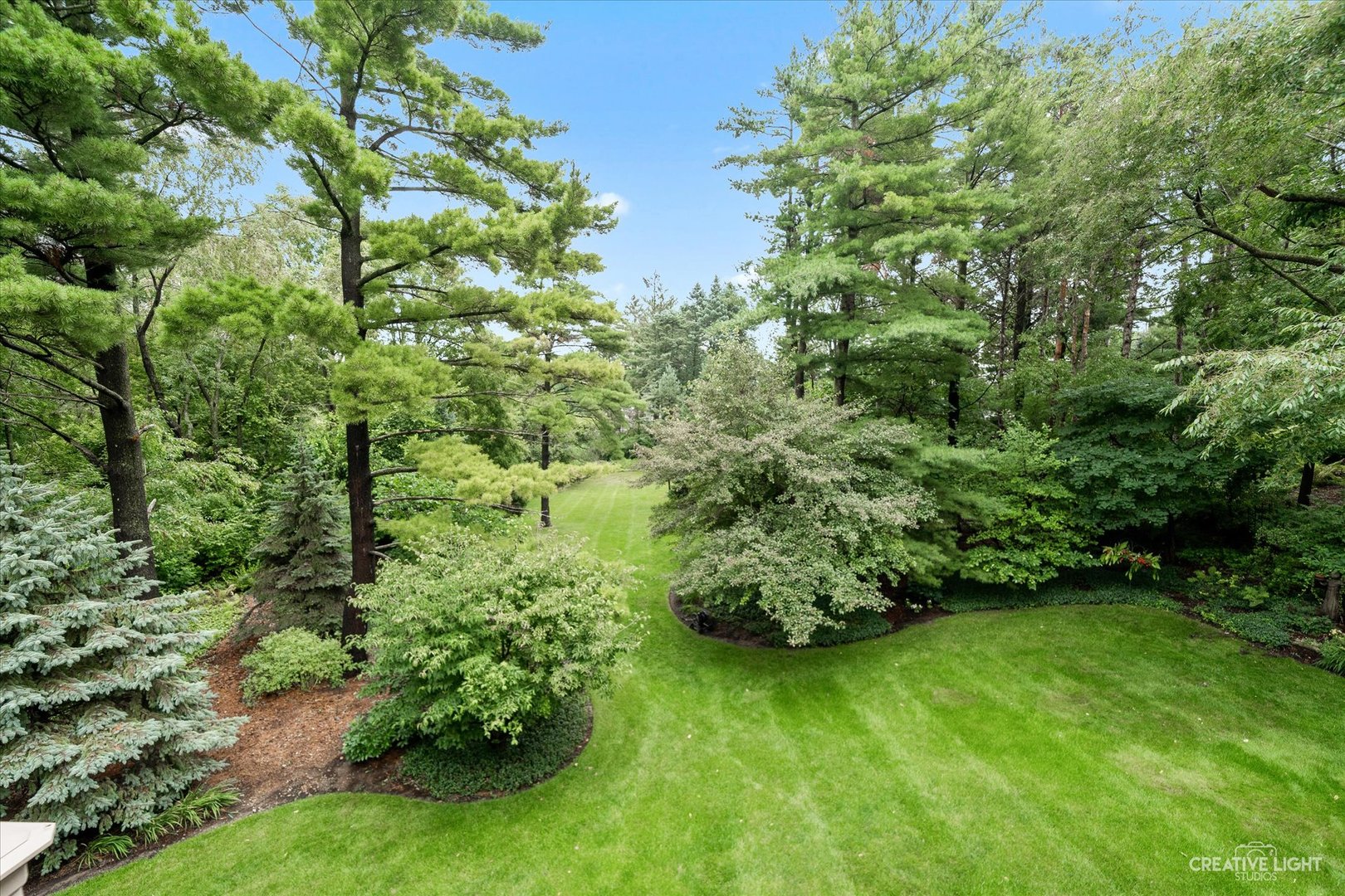 3293 Oak Knoll Road Carpentersville, IL 60110 - Photo 38 of 44 a view of a garden with a bench
