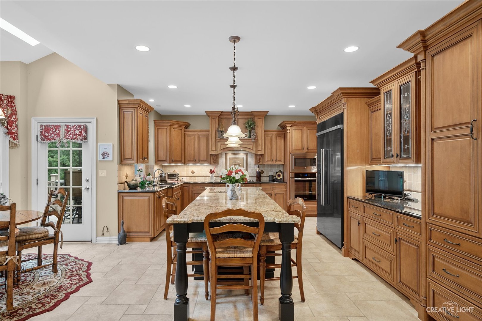 3293 Oak Knoll Road Carpentersville, IL 60110 - Photo 10 of 44 a large kitchen with a table and chairs