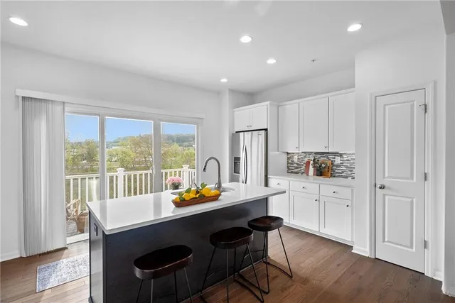 a kitchen that has a table and chairs in it
