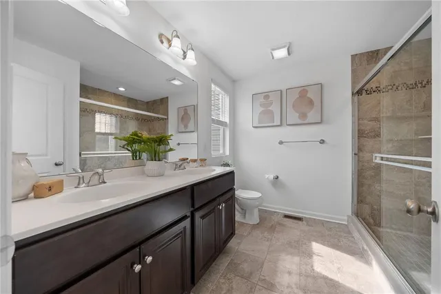a bathroom with a sink double vanity and a mirror