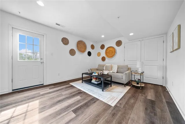 a living room with furniture and wooden floor