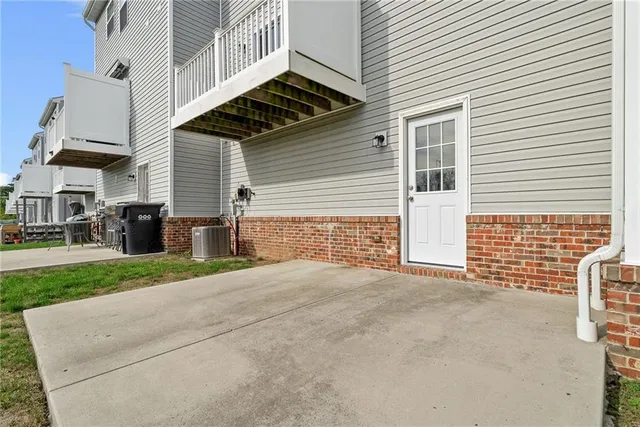a view of a house with a yard and potted plants