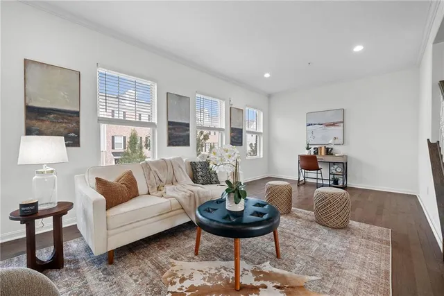 a living room with furniture and a wooden floor