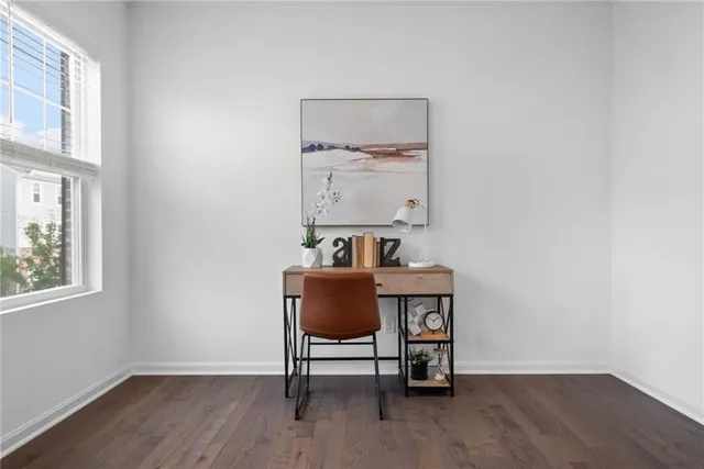a view of a workspace with furniture and wooden floor