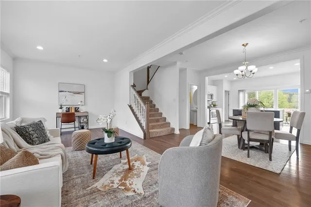 a living room with furniture and a chandelier