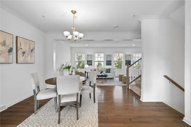 a view of a dining room with furniture wooden floor and a chandelier
