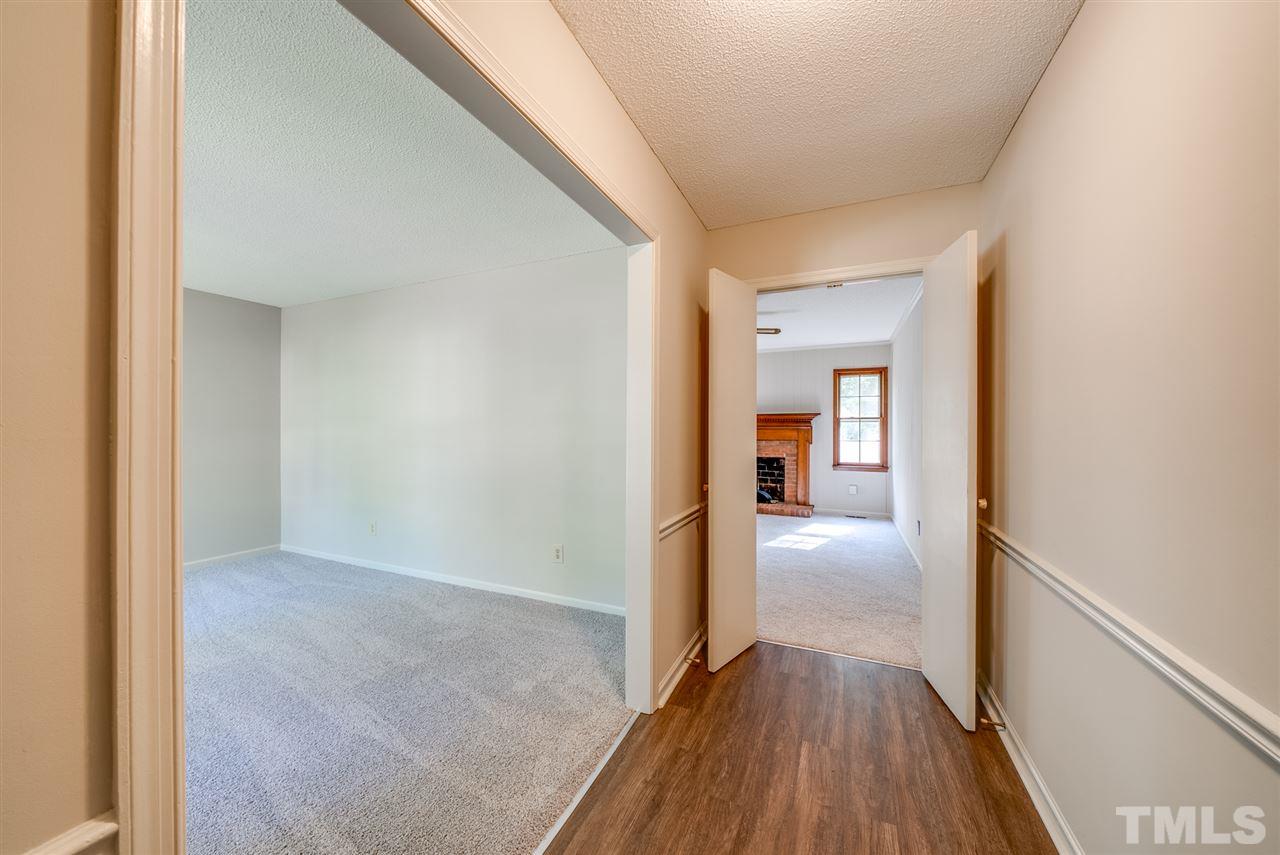 7408 Mine Shaft Road Raleigh, NC 27615 - Photo 2 of 20 a view of a hallway view with wooden floor and staircase
