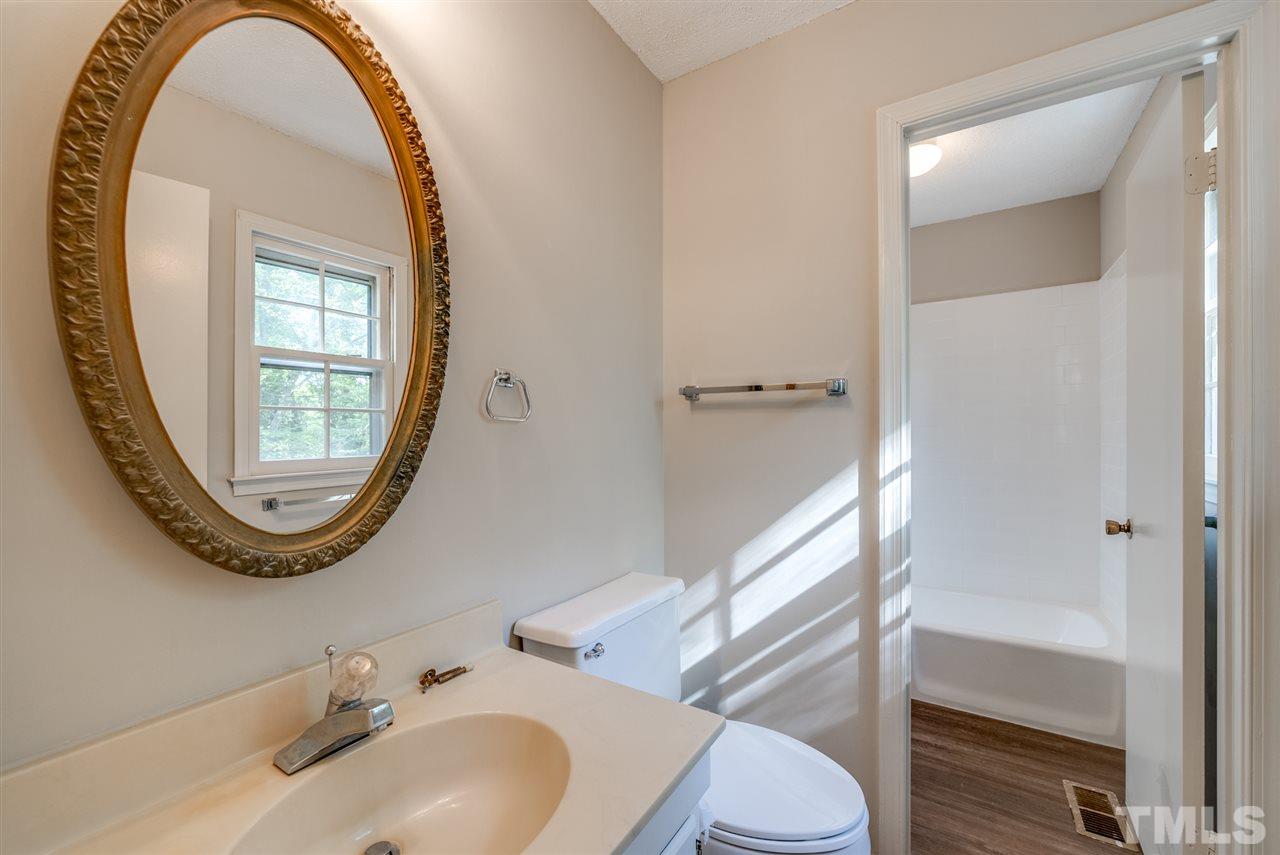 7408 Mine Shaft Road Raleigh, NC 27615 - Photo 12 of 20 a bathroom with a sink and a mirror