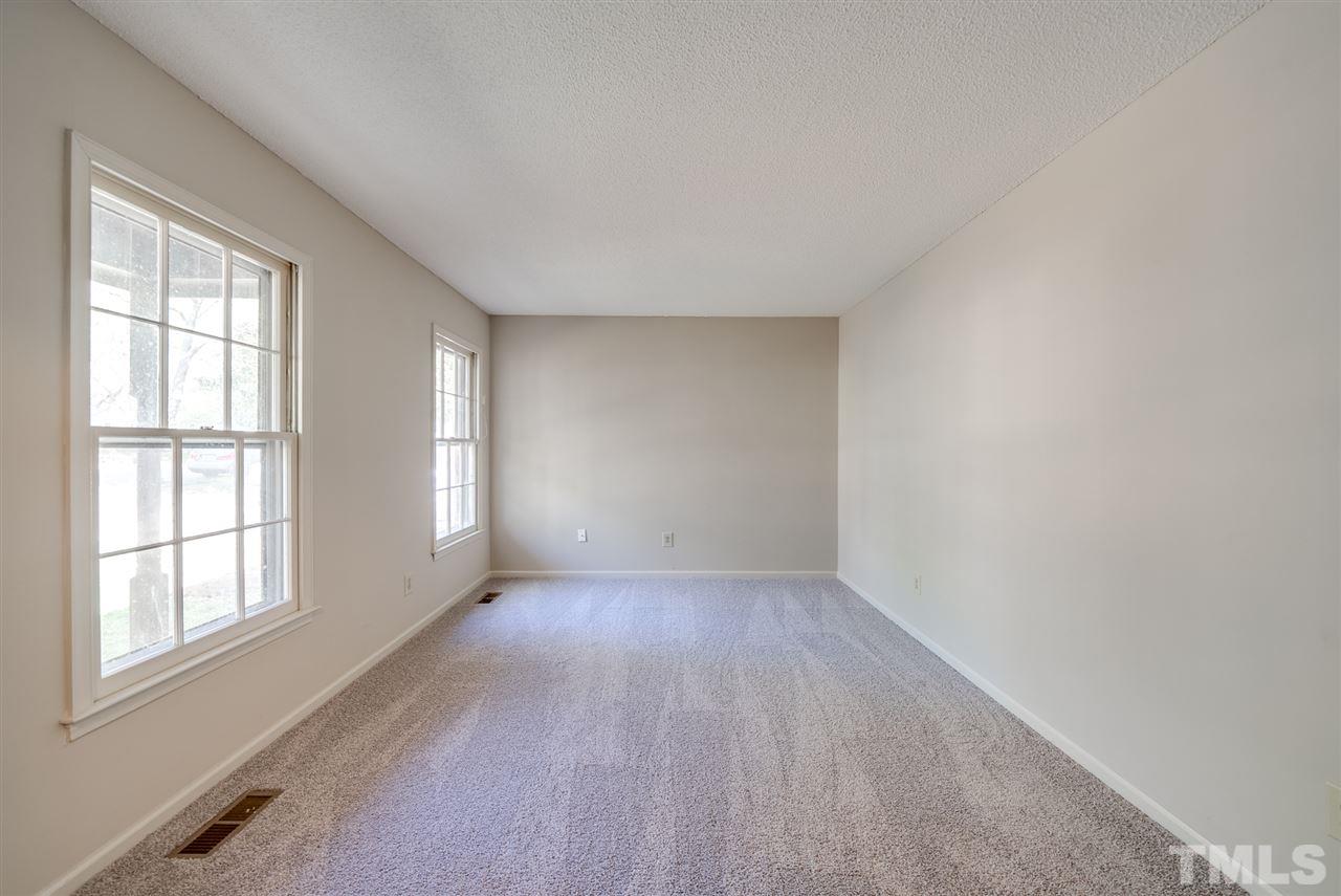 7408 Mine Shaft Road Raleigh, NC 27615 - Photo 3 of 20 an empty room with wooden floor and windows