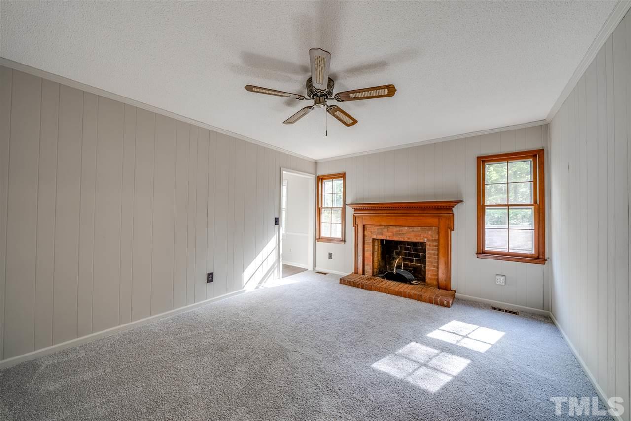 7408 Mine Shaft Road Raleigh, NC 27615 - Photo 5 of 20 a view of a livingroom with a fireplace and window
