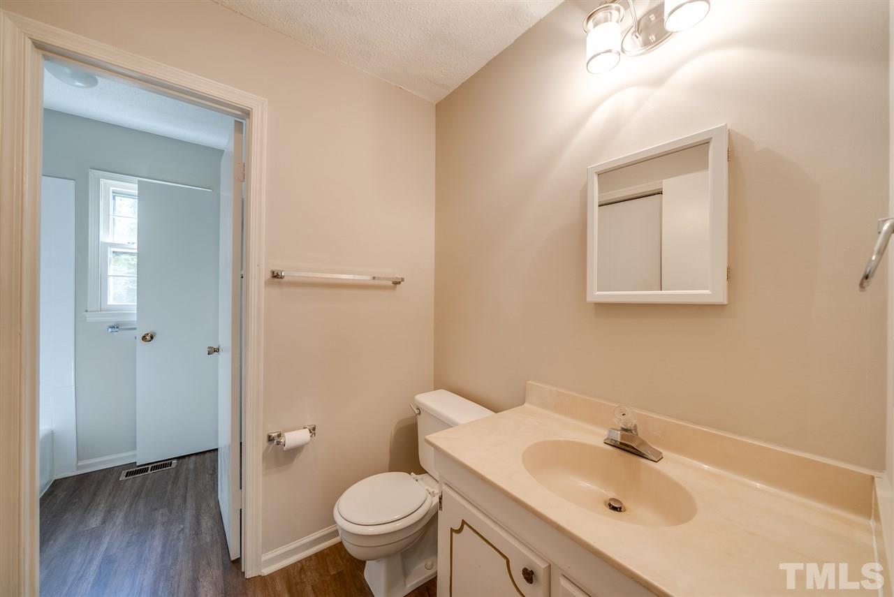 7408 Mine Shaft Road Raleigh, NC 27615 - Photo 7 of 20 a bathroom with a sink toilet and vanity