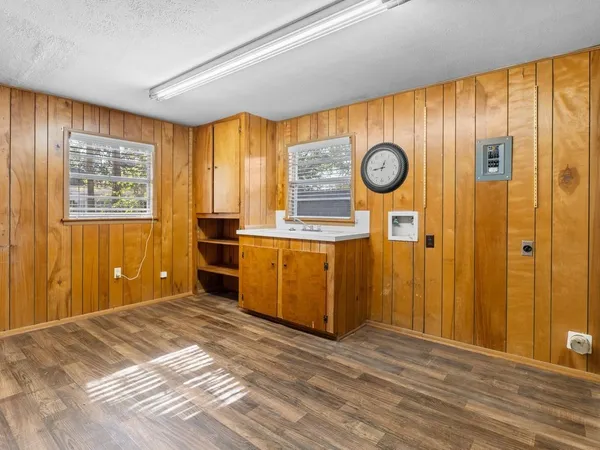 a view of a kitchen with wooden floor and window