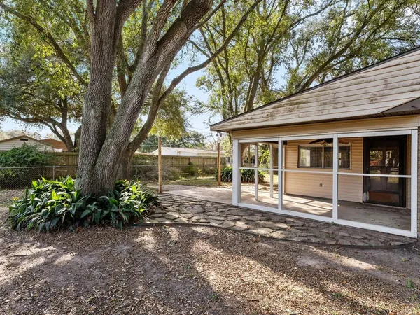 a front view of a house with a yard and potted plants