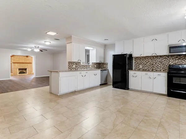 a kitchen with stainless steel appliances a refrigerator sink and cabinets
