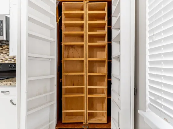 a view of a room with wooden floor and windows