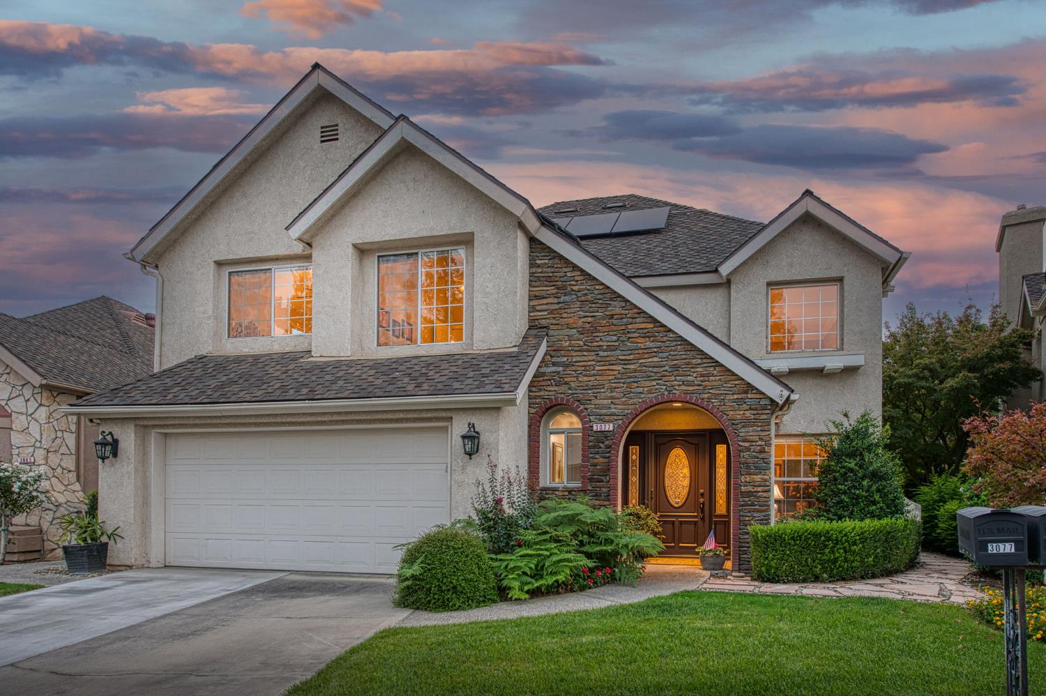 3077 West Pembrook Loop Fresno, CA 93711 - Photo 1 of 56 a front view of a house with a yard and garage