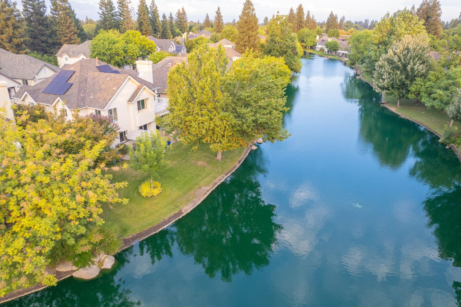 3077 West Pembrook Loop Fresno, CA 93711 - Photo 12 of 56 a view of a lake with lots of green space