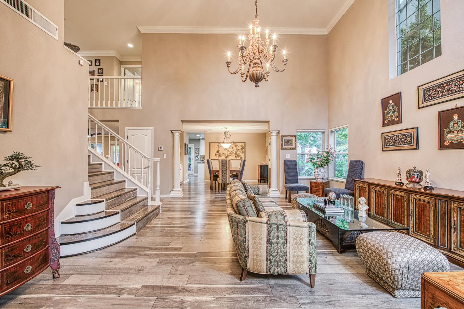 3077 West Pembrook Loop Fresno, CA 93711 - Photo 13 of 56 a living room with furniture and a chandelier