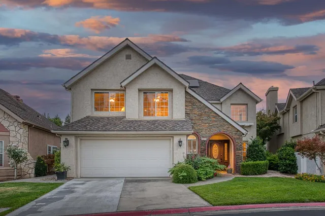a front view of house with yard and green space