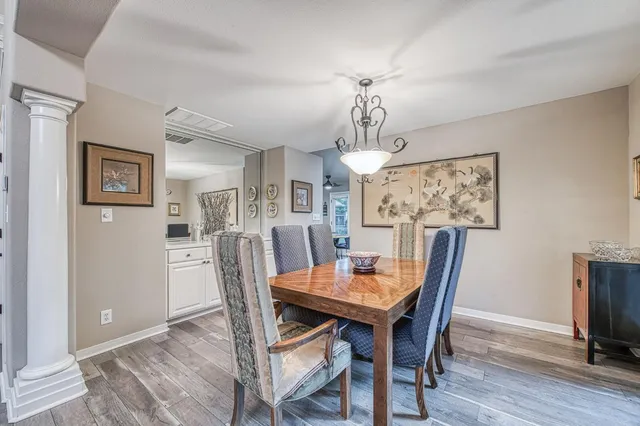 a view of a dining room with furniture window and wooden floor