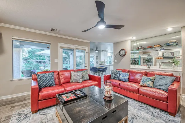 a dining room with furniture and a floor to ceiling window