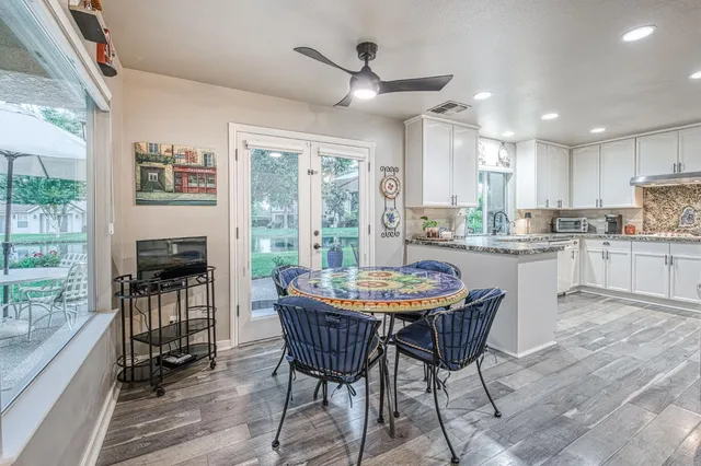 a kitchen with granite countertop a sink a stove and cabinets