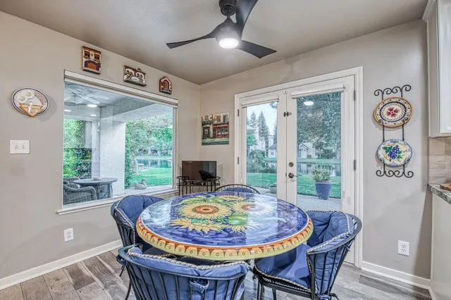 a kitchen that has a lot of white cabinets and a wooden floor