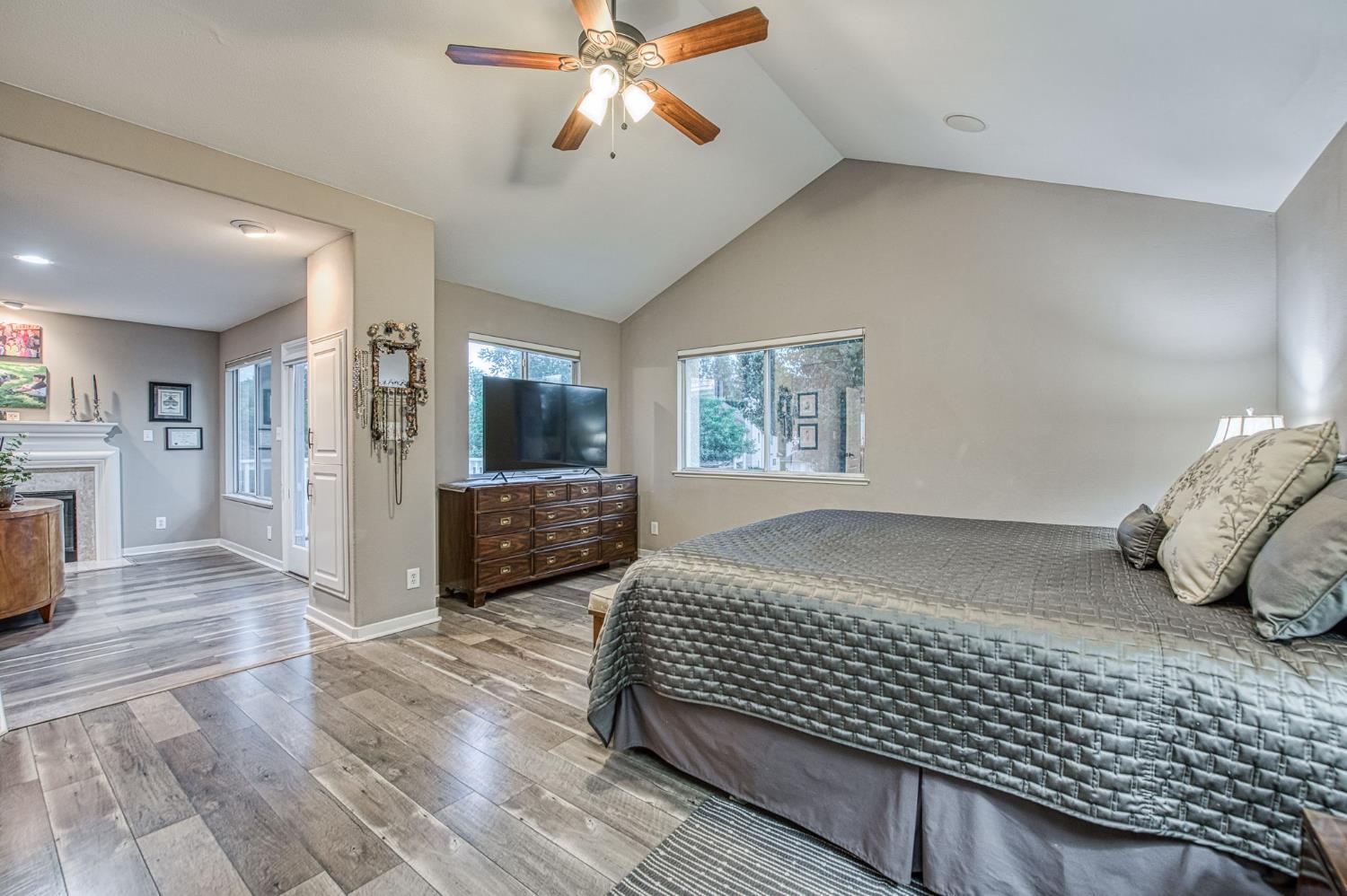 3077 West Pembrook Loop Fresno, CA 93711 - Photo 39 of 56 a bedroom with a bed and a chandelier