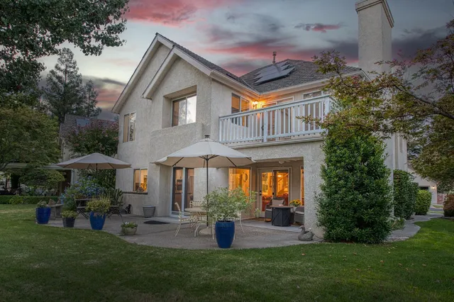 a view of a house with a yard and sitting area