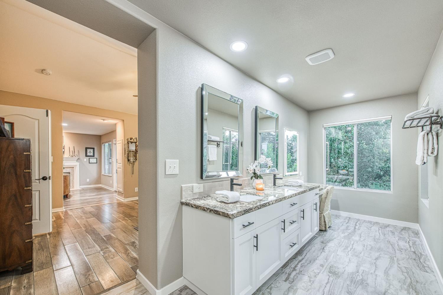 3077 West Pembrook Loop Fresno, CA 93711 - Photo 41 of 56 a bathroom with a double vanity sink and a large mirror