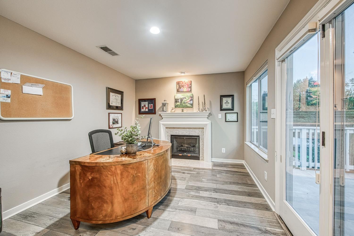 3077 West Pembrook Loop Fresno, CA 93711 - Photo 43 of 56 a living room with furniture a fireplace and a large window