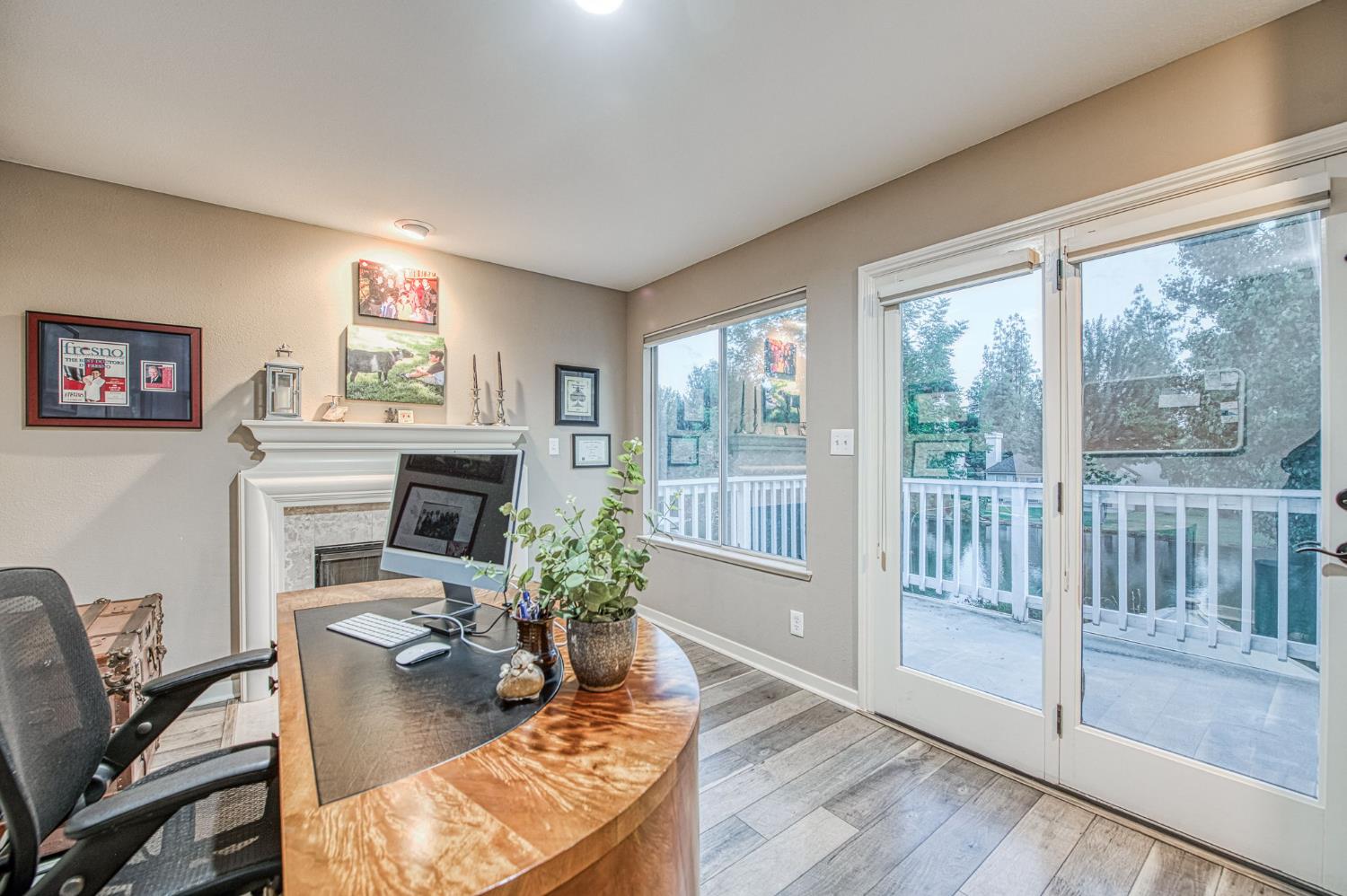 3077 West Pembrook Loop Fresno, CA 93711 - Photo 45 of 56 a living room with furniture a large window and a fireplace