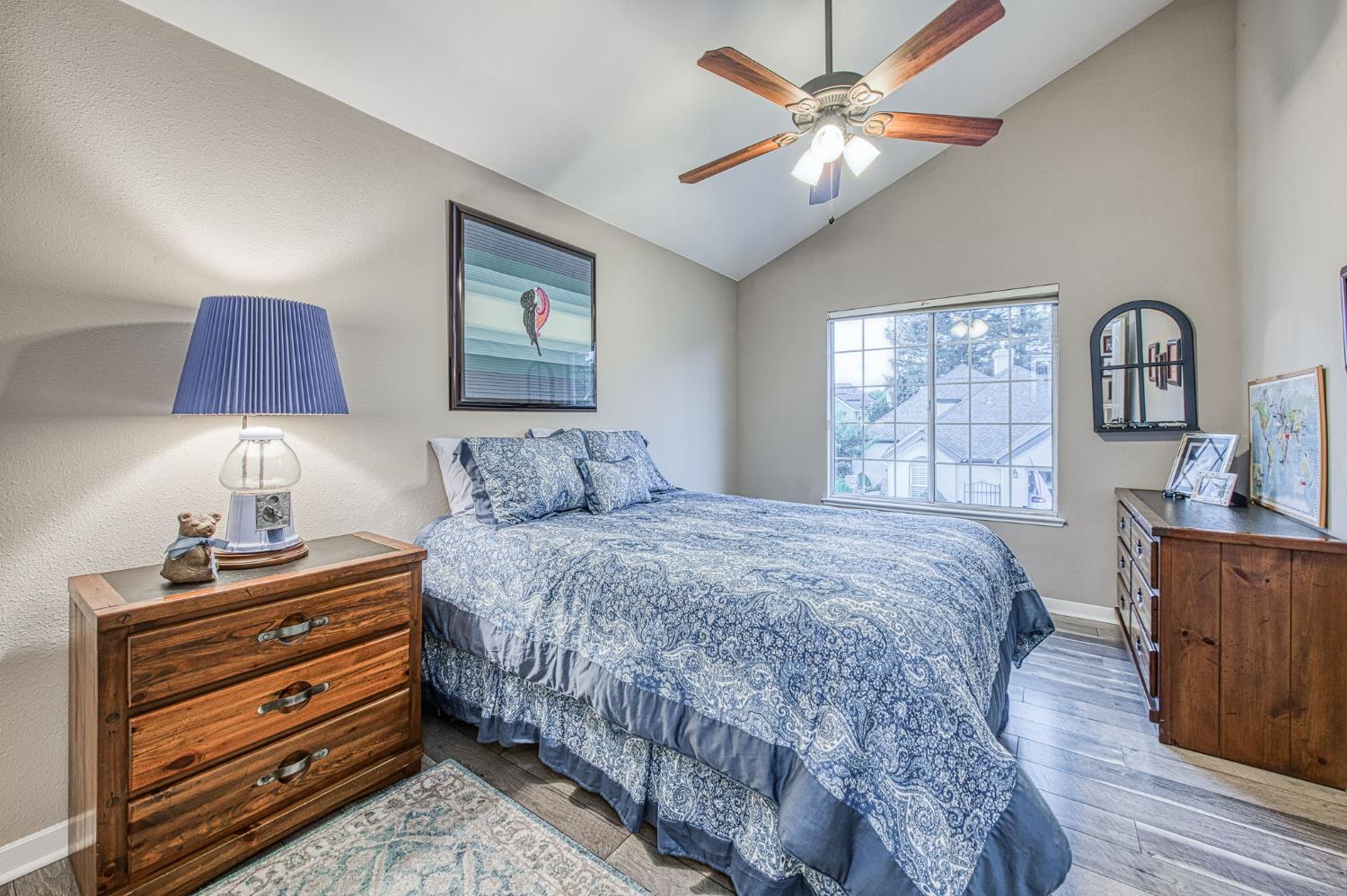 3077 West Pembrook Loop Fresno, CA 93711 - Photo 47 of 56 a bedroom with a bed and a dresser with wooden floor