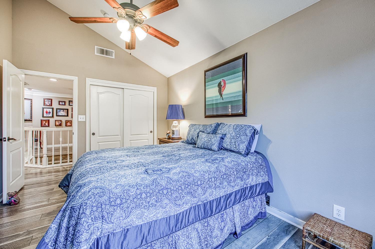 3077 West Pembrook Loop Fresno, CA 93711 - Photo 48 of 56 a bedroom with a bed and a chandelier