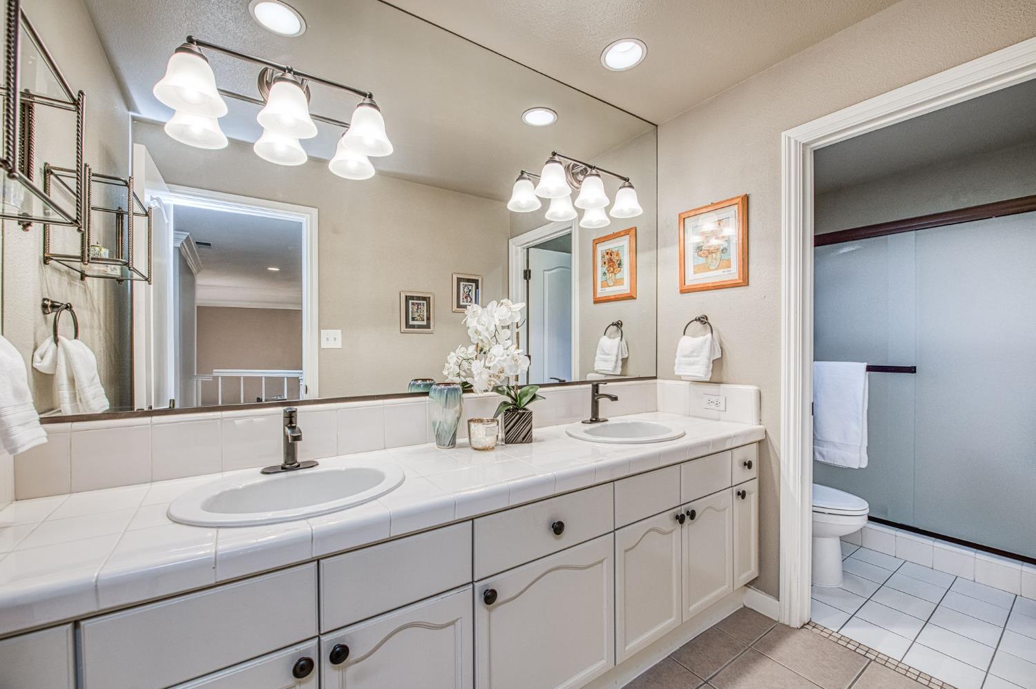 3077 West Pembrook Loop Fresno, CA 93711 - Photo 49 of 56 a bathroom with a sink double vanity and a mirror